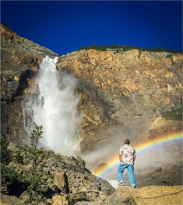 Travelers looking at photos of Takakkaw Falls