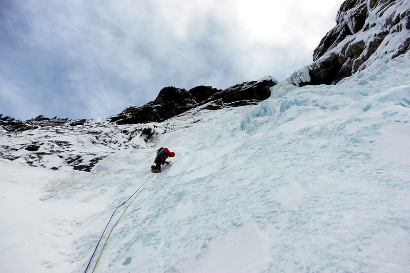 A man climbing an iceberg.